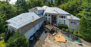 AOS Inc's roofing crew working on a residential home