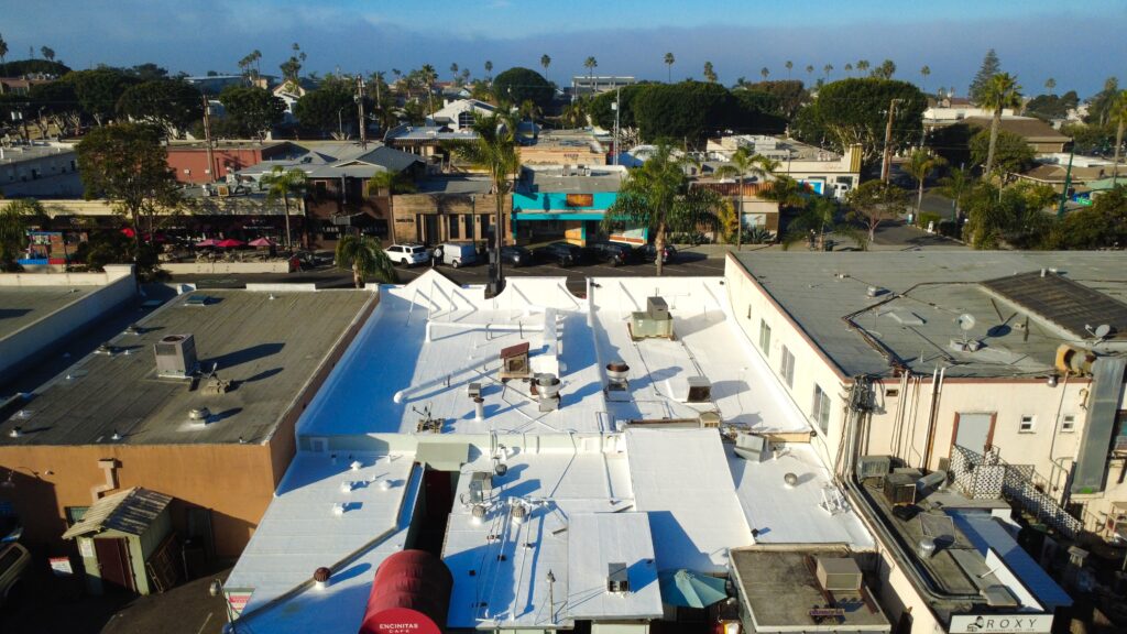 Downtown aerial showing white rooftop and palm trees
