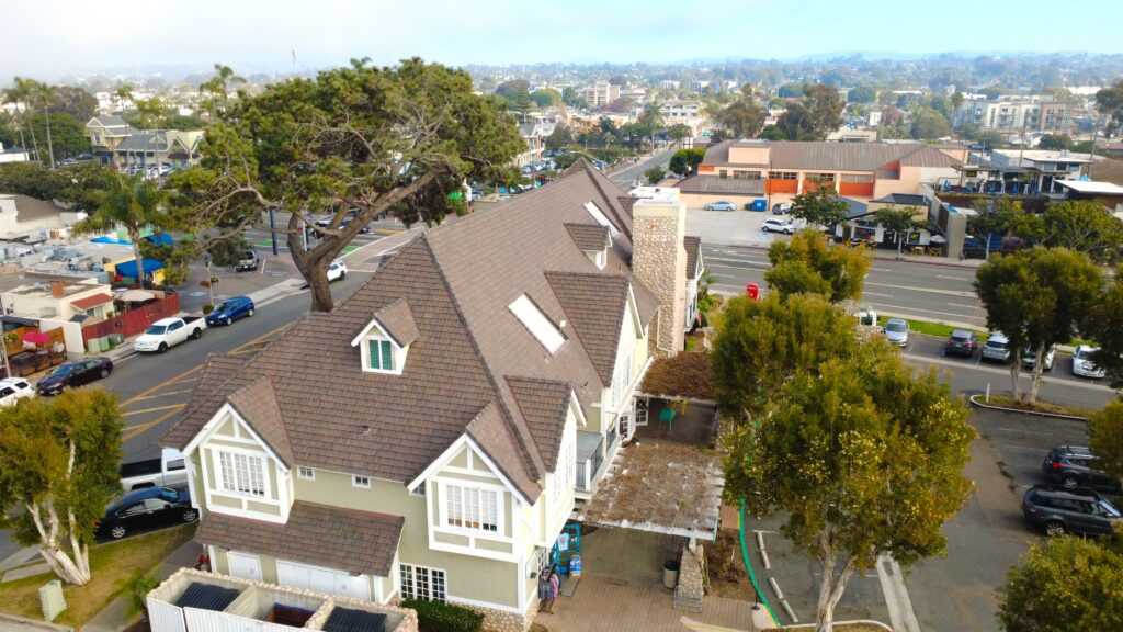 Aerial view of large house with brown roof
