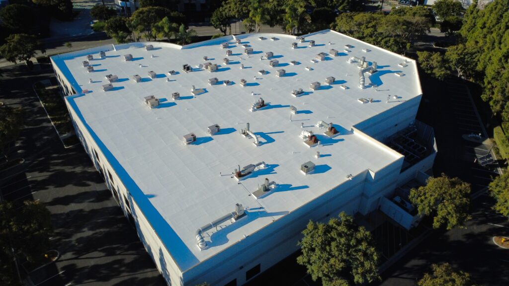White-roofed building with rooftop equipment.