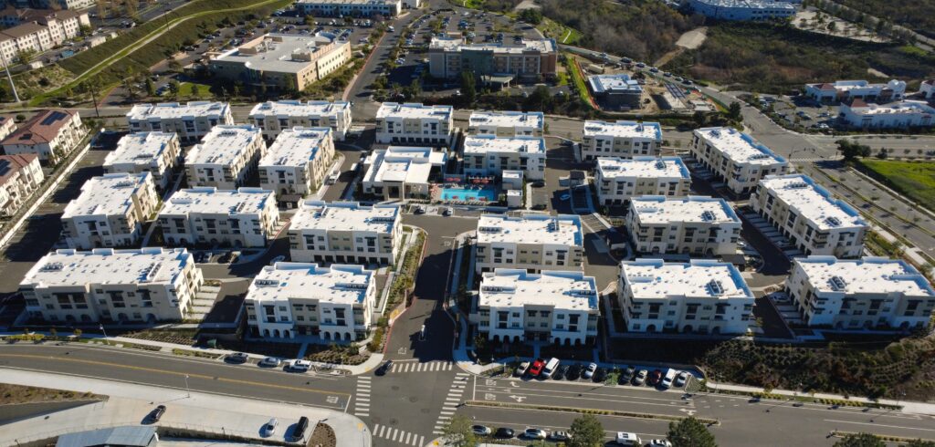 Aerial view of white-roof apartment complex
