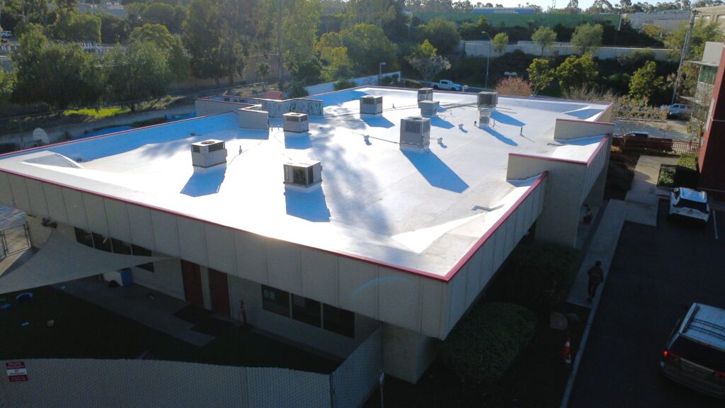 Aerial view of white flat roof HVAC shadows