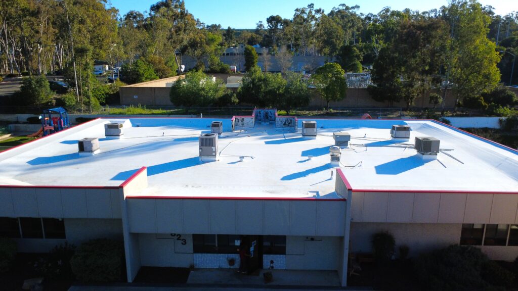 White commercial roof with red edge trim