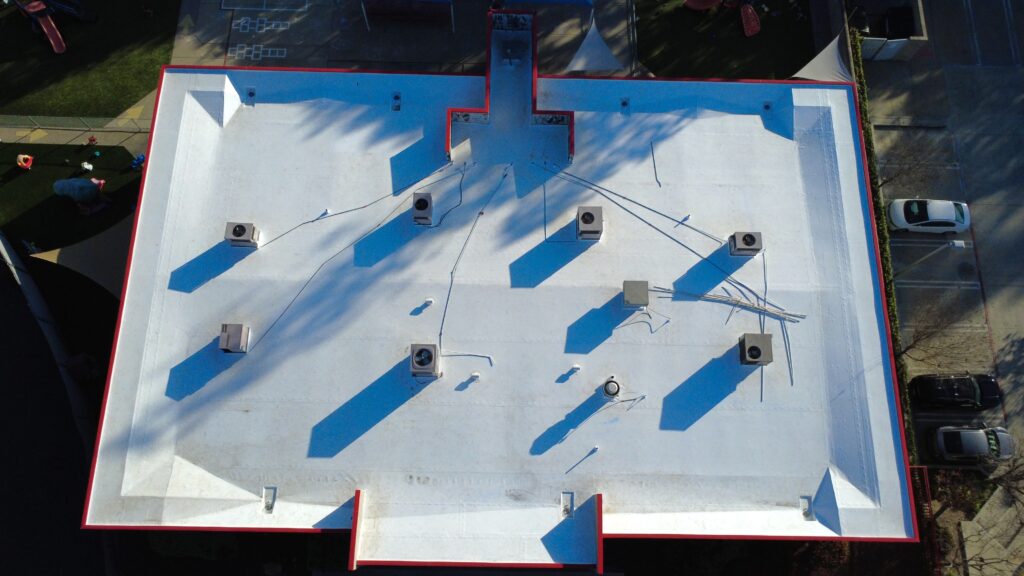 Top-down image of building roof and parking