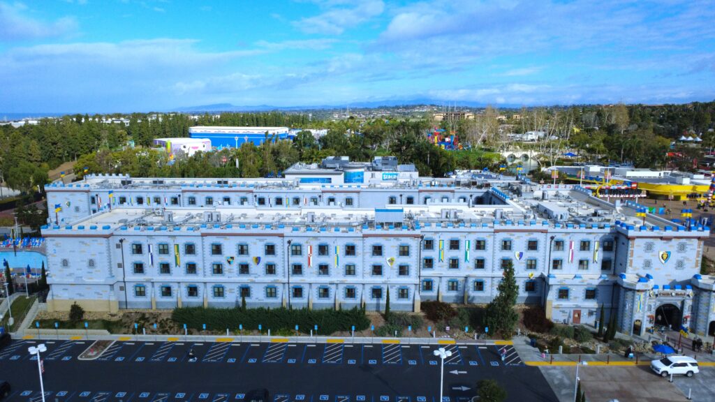 Front facade of castle-themed hotel with flags