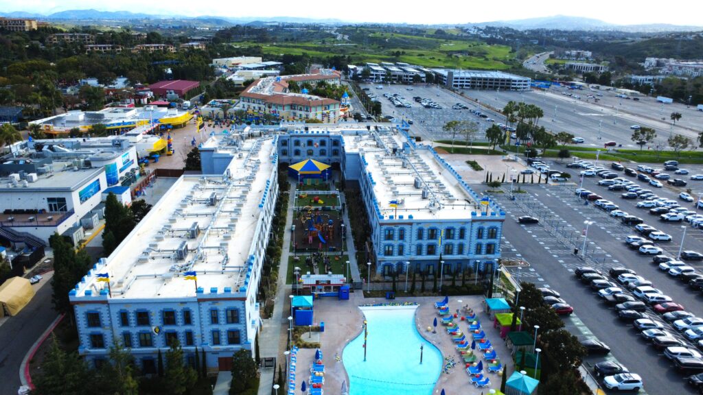 Overhead view of hotel, pool, and parking lot