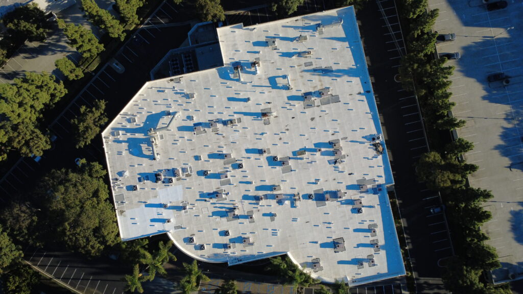 Aerial view of flat white rooftop with shadows