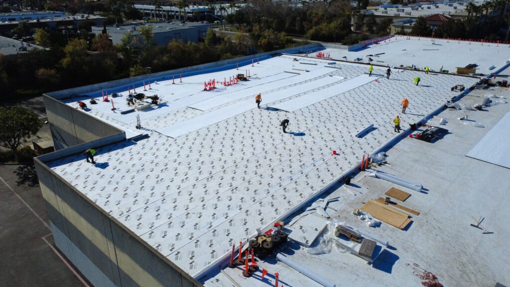Workers prepping rooftop for new coating