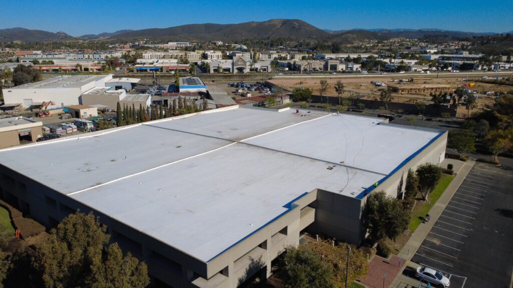 Industrial building with mountain landscape background.