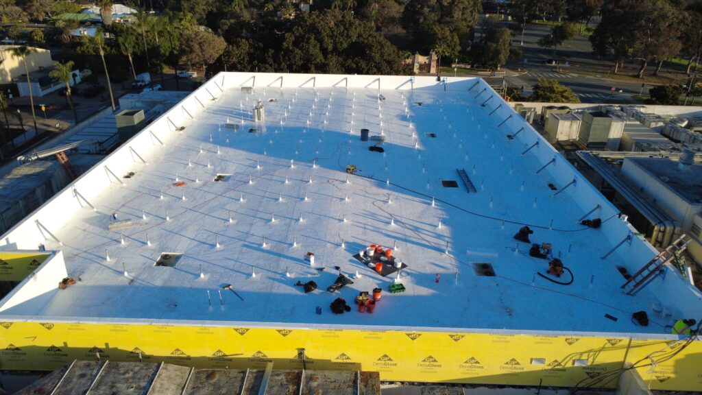 White flat rooftop with tools and vents