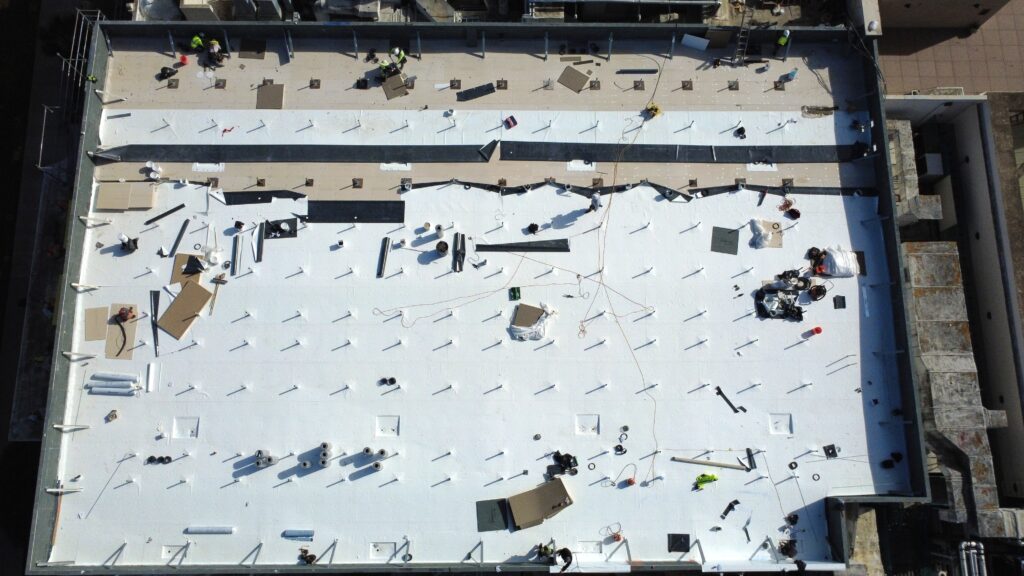 Top-down drone shot of commercial roof renovation