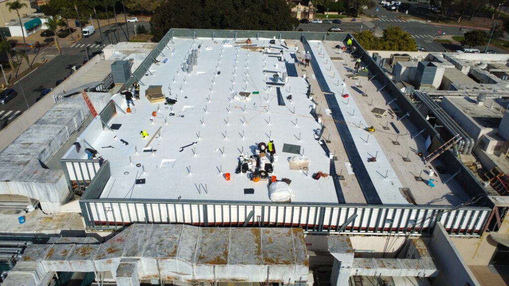 Aerial view of white flat roof under installation