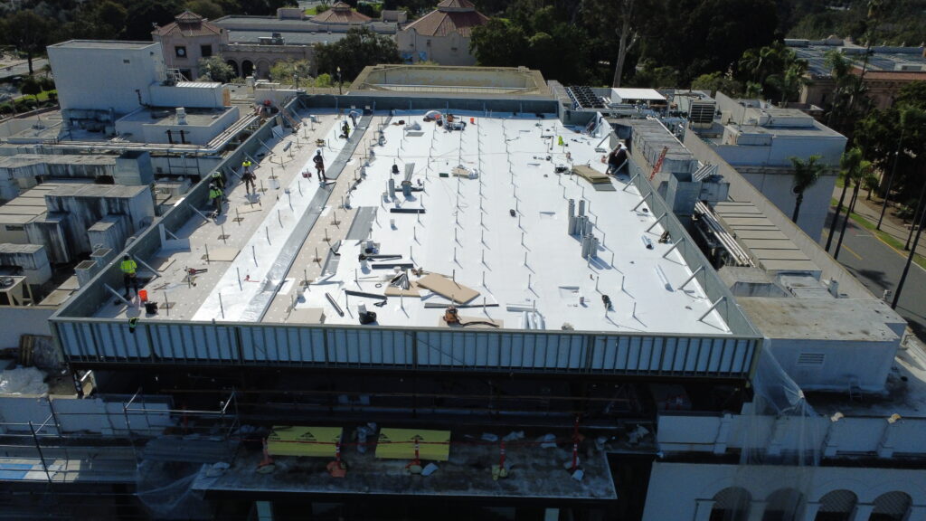 Workers renovating large rooftop structure