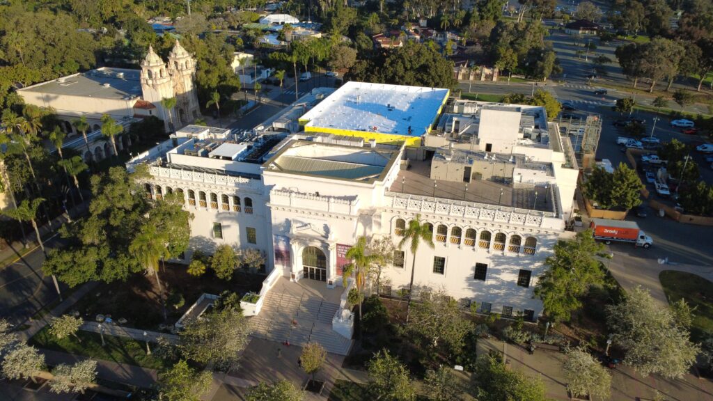 Museum building with rooftop and palm trees