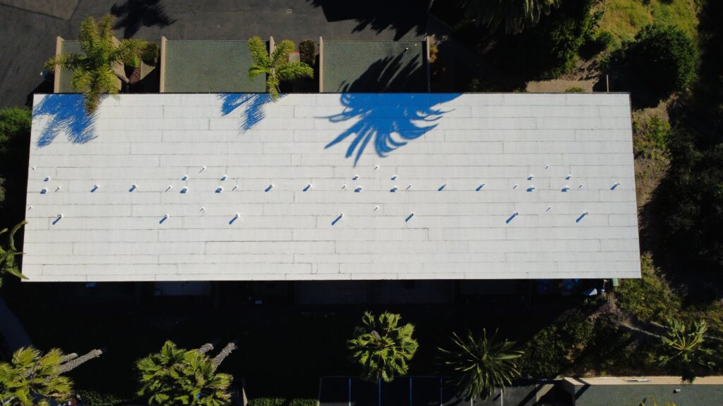 Top-down view of rooftop vents and shadows