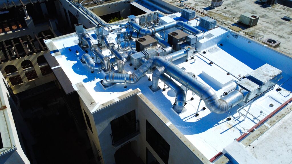 Silver HVAC ducts on white rooftop