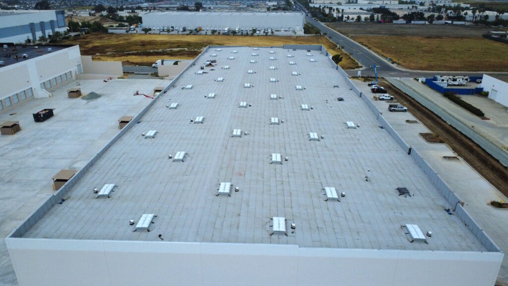 Aerial view of large industrial warehouse roof.