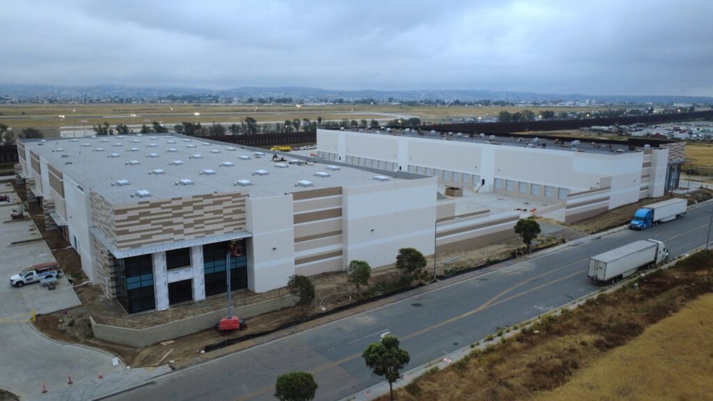 Large industrial building with surrounding road.